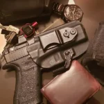 A gun, a wallet, and other accessories