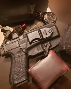 A gun, a wallet, and other accessories